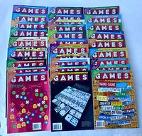 Top view of 31 colorful Games magazines laid out in rows, showing the front covers with puzzle themes.