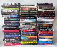 Photo showing a large stack of 53 hardcover fiction books from various authors, mostly mystery, thriller, and crime genre, arranged in five horizontal rows.