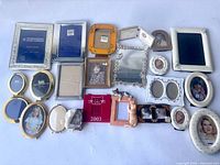 Full lot overview showing all 21 frames arranged on white surface including multiple materials and styles