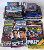 Top-down view of Star Trek magazines featuring vibrant covers with images of series cast members and titles.