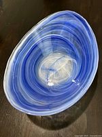Top-down view of the blue oval art glass bowl showing the swirl pattern.