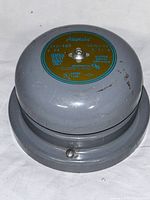 Top view of the gray metal Edwards Adaptabel 340-4G5 vibrating bell showing the label with specifications and certifications.