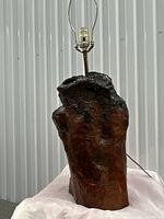 Front view of the handmade burl wood lamp showing natural wood grain and glossy finish.