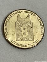 Front side of the coin showing Kobe Bryant jersey number 8 with years 1996-2006, and retirement date December 18, 2017.