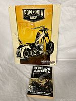 Metal POW MIA motorcycle-themed sign with a chopper motorcycle image and POW MIA text.