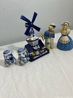 Vintage Dutch porcelain windmill, boy and girl figurines with salt and pepper shakers set on table