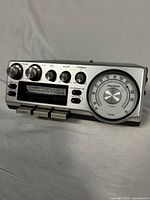 Full front view of vintage Pioneer car stereo showing cassette slot, rotary knobs, push and toggle buttons, and radio dial.