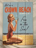Full view of the vintage style wooden plank beach art featuring woman in red swimsuit and text
