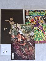 Three comics shown: Youngblood, Robyn Hood Legend issue #2, and ShadowHawk II black cover with gold bat silhouette.