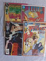 Photo showing four comic books: Green Lantern Emerald Dawn, Legion '91, Detective Comics Annual, and Team Titans #1