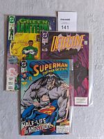 Photo showing all three comic books: Superman The Man of Steel #4, Detective Comics #617 (bagged), and Green Lantern #160