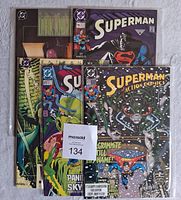 Five DC Comics featuring Superman and Batman, displayed together showing varied covers