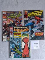Photo of three vintage Marvel comic books: Web of Spider-Man, Daredevil, and Spider-Man, arranged side by side showing front covers.