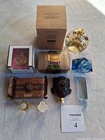 Full layout showing all items including boxed perfume ring, turtle figurine, blue cut glass, soap and small perfume bottles.