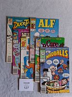 Photo showing all 6 vintage Star Comics comic books stacked and slightly fanned out, including titles DuckTales, ALF, Care Bears, Madballs, Muppet Babies, and Garfield.