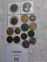 Top view of all 16 loose and holder coins showing various sides and designs