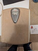 Full view of the Borg mechanical bathroom scale showing wooden platform and metal dial above.