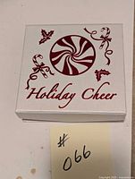 Holiday Cheer decorative gift box with peppermint candy design and festive lettering on lid.