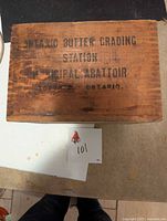 Top view of wooden butter box showing faded black lettering from the Butter Grading Station, Municipal Abattoir, Toronto, Ontario.
