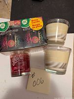Top view of 4 candles showing Air Wick 3-pack, Vanilla Icing, and Glade Rose Cinnamon candles