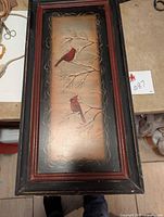 Full view of the framed cardinal artwork depicting two birds on pine branches with a rustic wooden frame.
