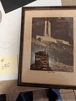 Framed picture showing entire artwork and part of table surface with sticky note labeled #040