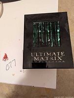 Front of the Ultimate Matrix Collection box set showing the green digital rain design and title.