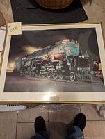 Framed photo of Union Pacific 3985 train in gold frame on floor