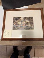 Framed artwork 'Fountain of Love' by Trish Romance shown from a distance, mounted under glass within a wooden frame.