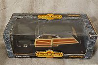 Front view of the '49 Merc Lead Sled die cast model car in original American Muscle box showing wood paneling detail and branding.