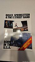 Front cover of Bruce Springsteen & The E Street Band tour program, white background with multiple photos and red diagonal banner.