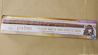 Photo of the packaged Hermione Granger wand with branding and age recommendation.