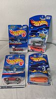 Five Hot Wheels cars in package displayed upright showing front of packaging