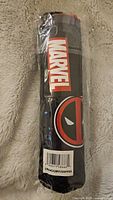 Image showing the Marvel branding and Deadpool logo on the umbrella packaging.