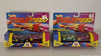 Two Hot Wheels Top Speed Solar Flare sets in original packaging showing both car sets with launcher and accelerator tube.