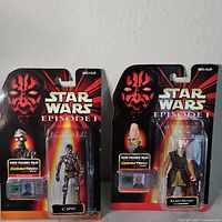 Two Star Wars Episode 1 figures, C-3PO and Ki-Adi-Mundi, in original sealed packaging with Darth Maul graphic on header card.