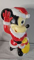 Front angle of the vintage Mickey Mouse blow mold dressed in Santa Claus outfit, showing full figure and yellow sack.