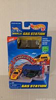 Front view of the vintage Hot Wheels Gas Station toy set in original packaging, showing the toy car and gas station with branding and label details.