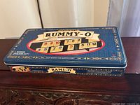 Closed metal tin box for Rummy-O game with retro design