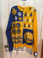 Front view of a brand new XXL Golden State Warriors Christmas sweater in blue and yellow with team logos, holiday designs, and patterns.