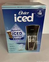 Front view of Oster iced coffee maker box showing product image, branding and key features including RapidChill technology.