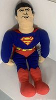 Full view of the large Superman plush doll showing the entire body and costume details.