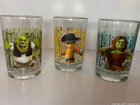 Set of three Shrek-themed McDonald's collectible glasses showing Shrek, Donkey, and Fiona characters.