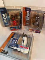 Three NBA McFarlane figures in their original packaging: Okafor, Finley, and Marbury