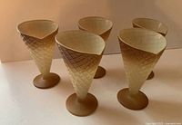 Front view of the set of five waffle cone shaped glasses, showing the waffle texture detail and bases.