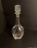Front view of the clear crystal decanter with stopper, showing the shape and stopper detail