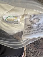 Close-up of certification and material content labels on pillow packaging