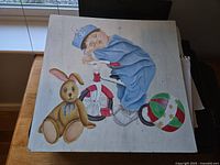 Front view of painting with baby, rabbit and ball