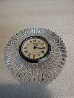 Top view of round faceted crystal bedside clock showing dial