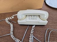 Top view showing keypad, handset, cords